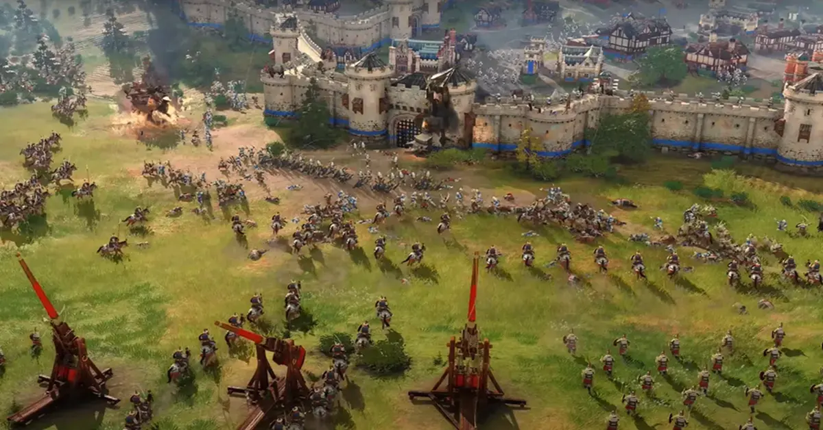 Captura de pantalla del juego Age of Empires IV que muestra un asedio medieval a gran escala con trabuquetes y unidades de caballería
