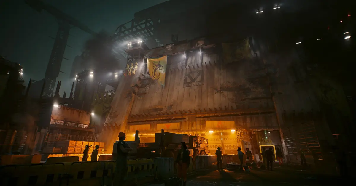 Un personaje jugador mirando la entrada fuertemente fortificada al distrito de Dogtown en Cyberpunk 2077
