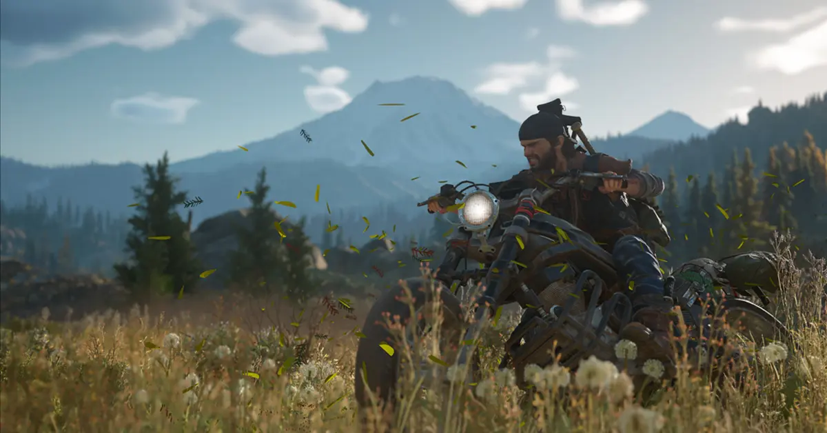Deacon St. John conduciendo su moto drifter fuertemente modificada a través de un exuberante pero peligroso bosque del noroeste del Pacífico en Days Gone.